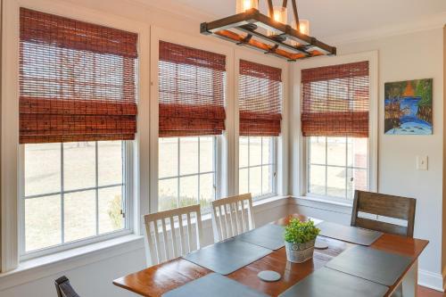 a dining room with windows and a table and chairs at Family-Friendly Home on Large Plot in Lebanon in Lebanon