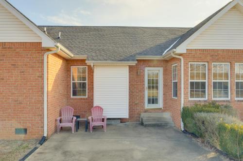 two pink chairs sitting outside of a brick house at Family-Friendly Home on Large Plot in Lebanon in Lebanon