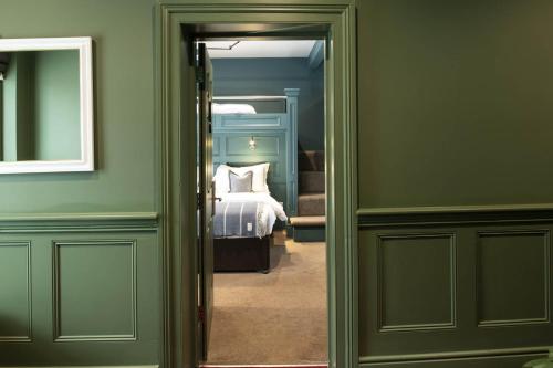 a room with a bedroom with a bed and a mirror at Silken Thomas Accommodation in Kildare