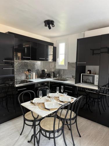 une cuisine avec une table et des chaises dans une cuisine dans l'établissement Charmant studio cœur de ville Saint Tropez, à Saint-Tropez