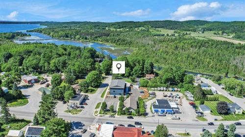 an aerial view of a town with a river at The Birches in Lake Leelanau