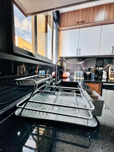 a kitchen with three drying racks on a counter at Elegant & Contemporary Stay in Temara