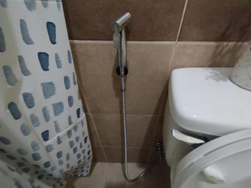 a shower in a bathroom with a toilet at Minimalist 1 Bedroom Condo at Arezzo Place Davao in Davao City