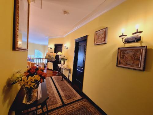 a hallway with a room with a table with flowers at Villa Bellissimo FranTalia in Kelowna