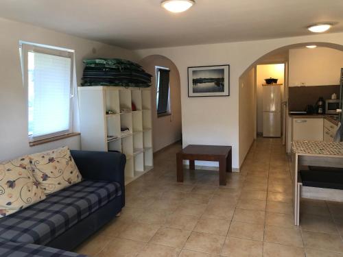 a living room with a couch and a table at Kertből a Balatonra in Révfülöp