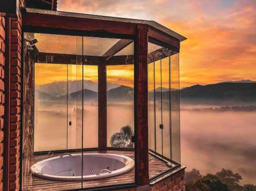 a room with a window with a view of the mountains at Refúgio Terras Altas in Itanhandu