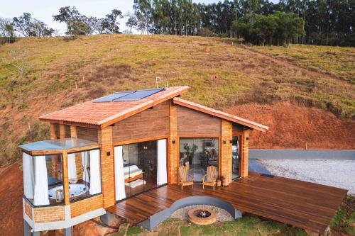 a small house with solar panels on top of it at Refúgio Terras Altas in Itanhandu