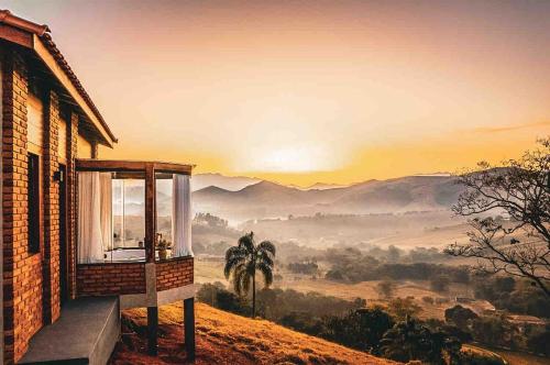 a house with a window with a view of the mountains at Refúgio Terras Altas in Itanhandu