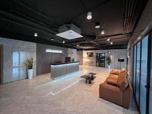 a living room with a couch and a table at NBG d 'amore Appart in Batumi