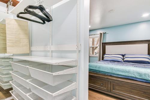 a bedroom with a bed and a glass closet at 6 Mi to Spectrum Center: Spacious Getaway w/ Deck in Charlotte