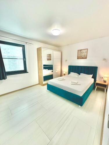 a large bedroom with a bed and a window at B2 Boutique Apartments in Năvodari