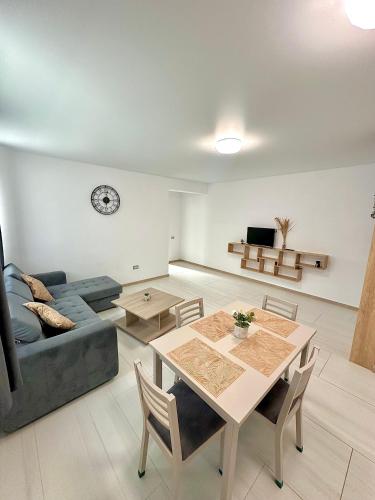 a living room with a table and a couch at B2 Boutique Apartments in Năvodari