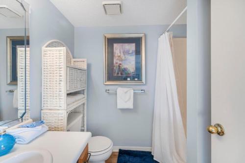 a bathroom with a sink and a toilet and a mirror at Bayview 55 by Vacation Homes Collection in Orange Beach