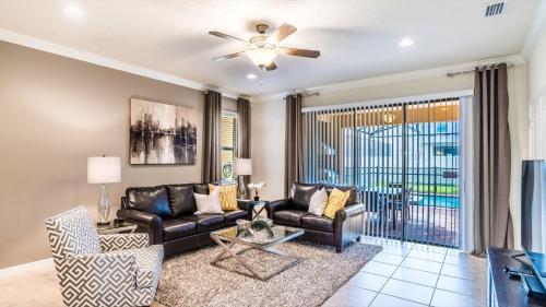 a living room with a couch and a ceiling fan at ROM2112 in Los Angeles
