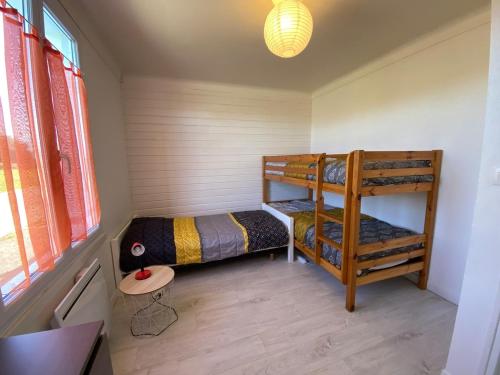 two bunk beds in a small room with a window at Le Jaunay holiday in Saint-Gilles-Croix-de-Vie