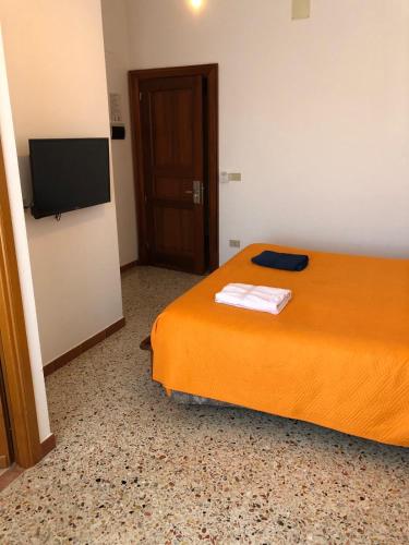 a bedroom with a bed and a flat screen tv at Albergo BELVEDERE in Santa Cristina Gela