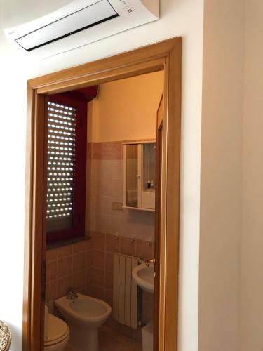 a bathroom with a toilet and a sink at Albergo BELVEDERE in Santa Cristina Gela