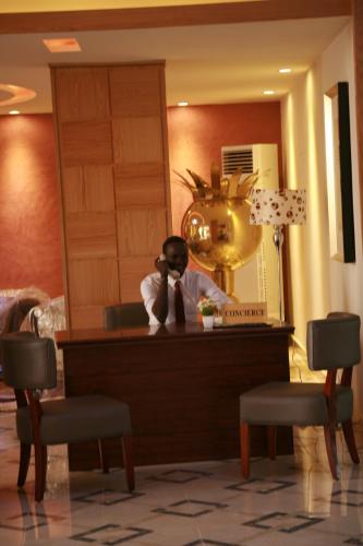 a man in a mirror in a hotel room at Crown Hotel Juba in Juba