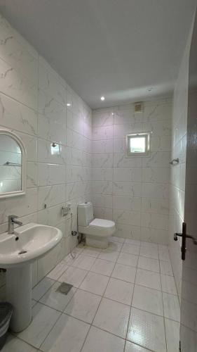 a white bathroom with a sink and a toilet at درة العروس البرادايس دور علوي عوائل فقط in Durat Alarous