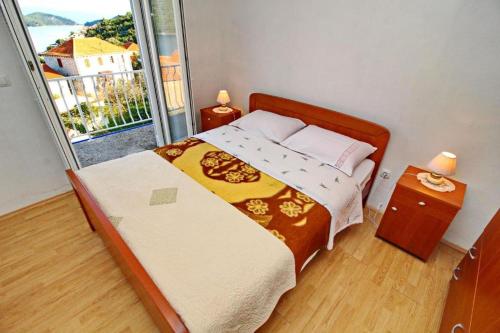 Postel nebo postele na pokoji v ubytování Apartments Nodilo