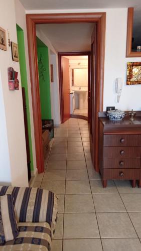 a hallway leading to a room with a bedroom at Casa Luisa in Jerzu