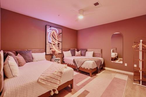 a bedroom with two beds and a mirror at Hyve in Nashville