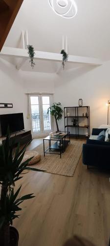 un salon avec un canapé et une table dans l'établissement La Suite Mìmì 光 Duplex - 2chambres2Sallesd'eau - Second Lodge Rennes, à Rennes