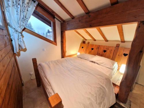 a bedroom with a bed in a room with a window at Chalet Rianne - Beau chalet 8/10 personnes MAE-9554 in Modane
