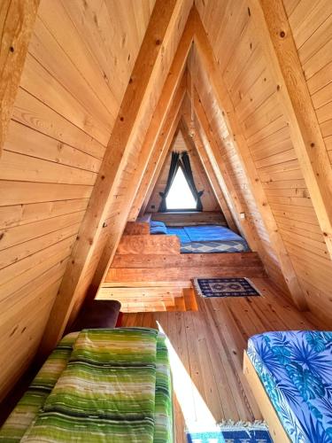 a room in a tree house with two beds at Etno apartmani Komarnica in Šavnik