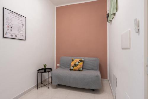 a room with a chair with a pillow on it at Giufrania Suite in Castellammare di Stabia