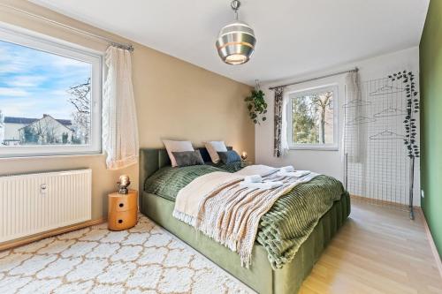 a bedroom with a bed and a large window at 3 Zimmer, Beamer, Balkon, Disney Plus in Woltersdorf