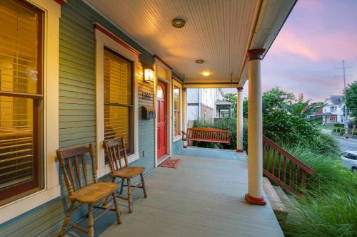 a porch with two chairs on a house at Home with Garage, Hot Tub, near OSU & Short North in Columbus