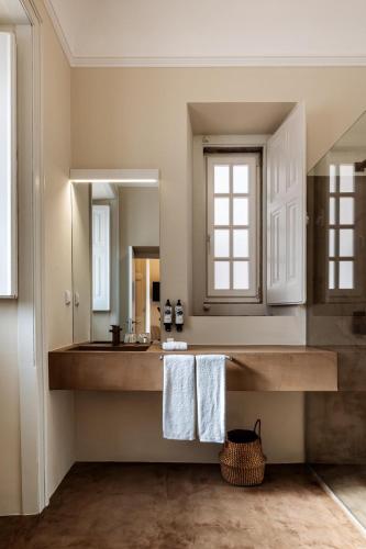 a bathroom with a sink and a mirror at CICIOSO boutique hotel in Évora