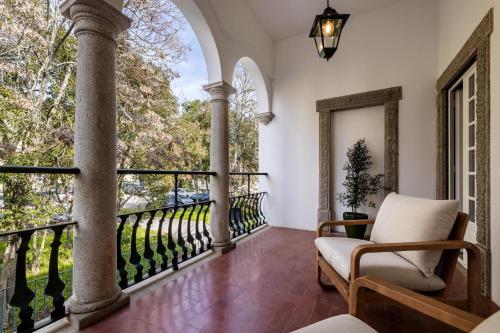 a balcony with a chair and a window at CICIOSO boutique hotel in Évora