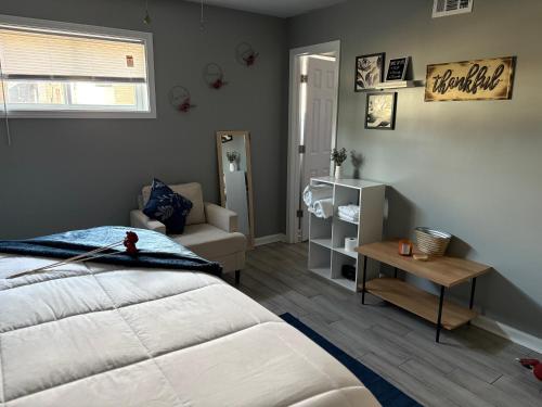 a bedroom with a bed and a chair and a mirror at Memphis Getaway in Memphis