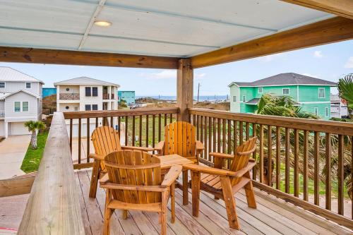 a patio with chairs and a table on a deck at Casa Playa - Ocean Views Pet Friendly Boardwalk in Port Aransas