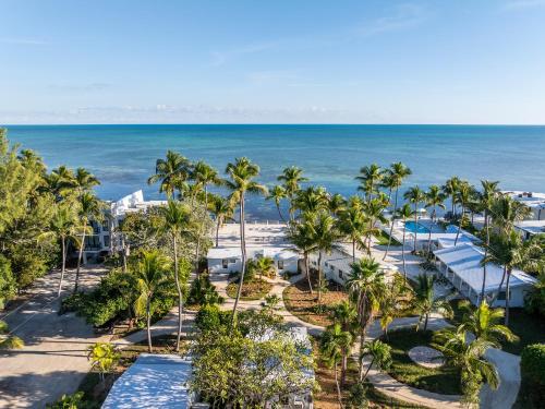 an aerial view of a resort with palm trees and the ocean at Pines & Palms Resort in Islamorada