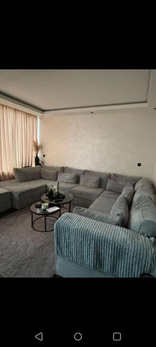 a living room with a couch and a table at Hébergement family in Lelystad