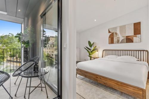 a bedroom with a bed and a balcony at Modern Apartments in Clausen with WiFi, Kitchen & Workspace in Luxembourg