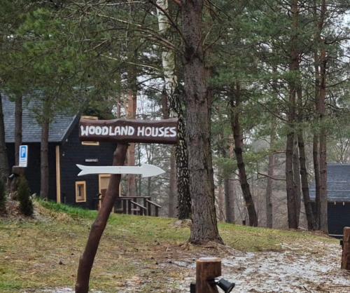 a sign for a woodland house in a park at Woodland House 1 in Berezka