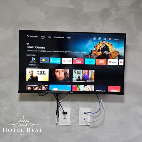 a flat screen tv with a hotel real website at Hotel Real in Ouro Preto