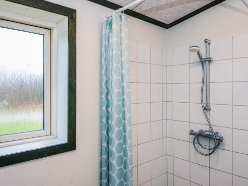 a bathroom with a shower with a shower curtain at 4 star holiday home in Hovborg-By Traum in Hovborg