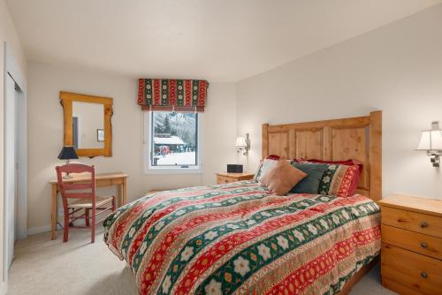 a bedroom with a bed and a desk and a chair at Shadow Mountain Unit 15, Spacious Ski-In, Ski-Out Townhouse with Great Views & Gas Fireplace in Aspen