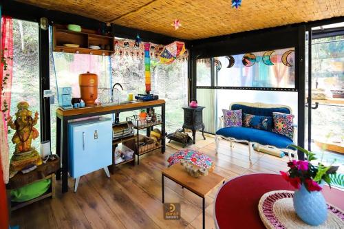 a room with a kitchen and a living room at Nirvana Glamping, Nature Glass Chalet in São Francisco Xavier