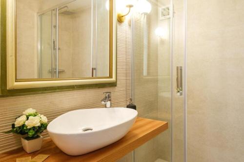 a bathroom with a white sink and a shower at Corte dei Mori 239 in Liscia di Vacca