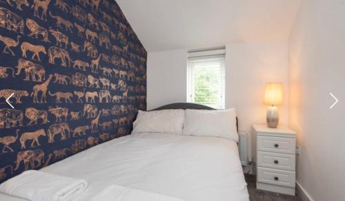 a bedroom with a bed and a wall of animals at Nelson 2 Double bedrooms 1 bathroom in Crook