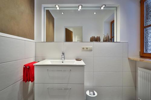 a white bathroom with a sink and a mirror at Gästehaus Alexandra in Ramsau