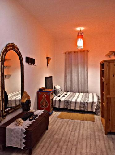 a bedroom with two beds and a large mirror at Casa Rakel in Chefchaouene