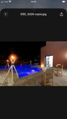 a picture of a swimming pool at night at VILLA NOÛR PALACE avec piscine jaccuzi à Marrakech in Marrakech