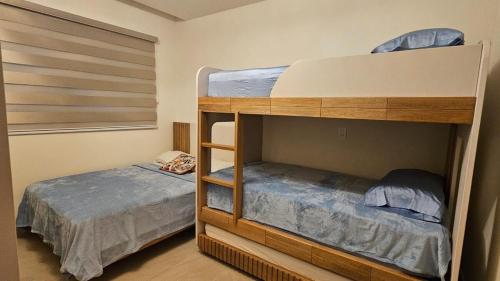 a bedroom with two bunk beds in a room at Playa Escondida in María Chiquita
